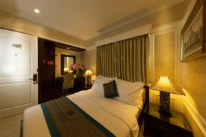 a hotel room with a bed and a lamp at Anpha Boutique Hotel in Ho Chi Minh City