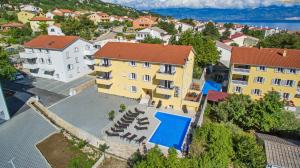 an aerial view of a building with a swimming pool at Apartments Gorica 2 in Baška