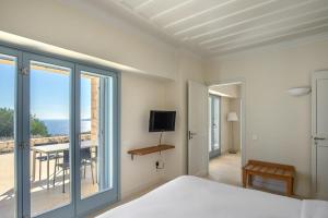 a bedroom with a bed and a view of the ocean at Urania Luxury Villas in Vasiliki +159 photos