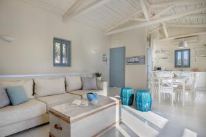 a living room with a couch and a table at Urania Luxury Villas in Vasiliki
