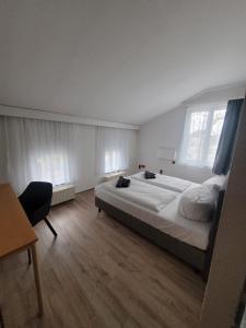 a bedroom with a large bed and a chair at Appartement-Hotel Rostock in Rostock +89 photos