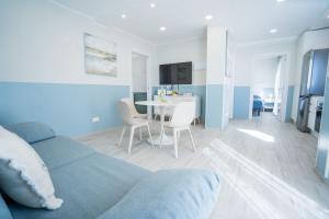 a living room with a couch and a dining room at Casa Marlene Luxury SeaFront in Güimar