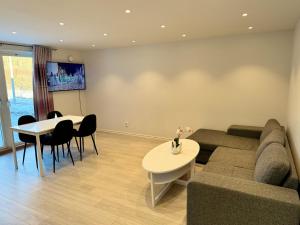 a living room with a couch and a table at Nice guesthouse with heat floor in Lilla Edet