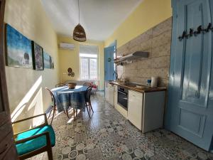 a kitchen with a table and a dining room at Ergzotic Apartments & Room in Sombor
