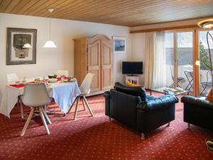 a living room with a table and chairs and a dining room at Apartment Chalet Abendrot apARTments-15 by Interhome in Grindelwald