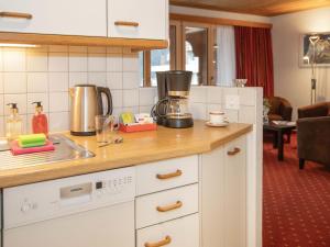 a kitchen with a counter top with a coffee maker at Apartment Chalet Abendrot apARTments-21 by Interhome in Grindelwald