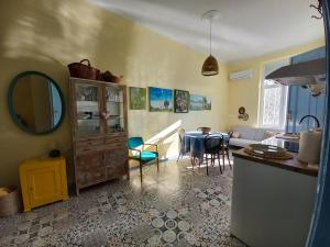 a kitchen and a living room with a table at Ergzotic Apartments & Room in Sombor