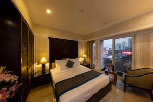 a hotel room with a bed and a large window at Anpha Boutique Hotel in Ho Chi Minh City