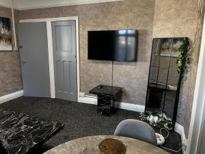 a living room with a flat screen tv on the wall at Levy Nook 9 in Darlington
