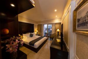 a hotel room with a bed and a window at Anpha Boutique Hotel in Ho Chi Minh City