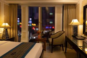 a hotel room with a bed and a window at Anpha Boutique Hotel in Ho Chi Minh City