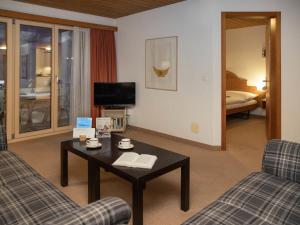 a living room with a couch and a coffee table at Apartment Chalet Abendrot apARTments-17 by Interhome in Grindelwald