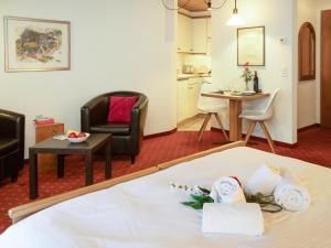 a hotel room with a bed and a table and chairs at Apartment Chalet Abendrot apARTments-7 by Interhome in Grindelwald