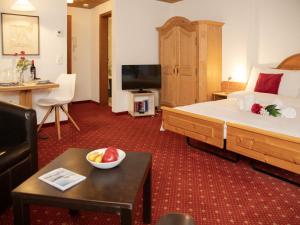 a hotel room with a large bed and a television at Apartment Chalet Abendrot apARTments-7 by Interhome in Grindelwald