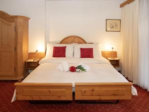 a bedroom with a large bed with flowers on it at Apartment Chalet Abendrot apARTments-7 by Interhome in Grindelwald