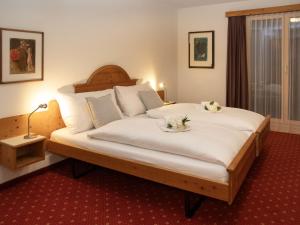 a bedroom with a bed with two dogs laying on it at Apartment Chalet Abendrot apARTments-24 by Interhome in Grindelwald