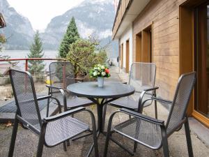 a table and chairs on a patio with a view at Apartment Chalet Abendrot apARTments-20 by Interhome in Grindelwald +27 photos