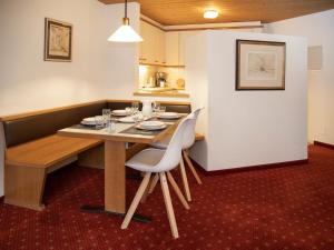 a dining room with a table and chairs at Apartment Chalet Abendrot apARTments-27 by Interhome in Grindelwald +30 photos