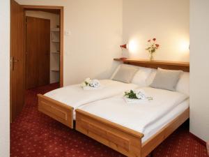 a bedroom with a bed with two towels on it at Apartment Chalet Abendrot apARTments-27 by Interhome in Grindelwald