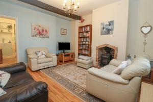a living room with two couches and a fireplace at Little Noo in Gloucester