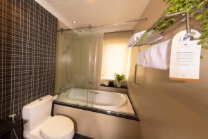 a bathroom with a toilet and a bath tub at Anpha Boutique Hotel in Ho Chi Minh City