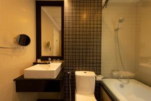 a bathroom with a toilet and a sink and a shower at Anpha Boutique Hotel in Ho Chi Minh City