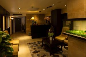 a lobby with a living room with a table at Anpha Boutique Hotel in Ho Chi Minh City