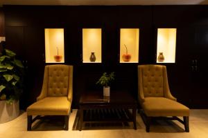 two chairs and a table in a room at Anpha Boutique Hotel in Ho Chi Minh City