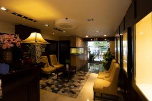 a lobby with a waiting room with chairs and a lamp at Anpha Boutique Hotel in Ho Chi Minh City