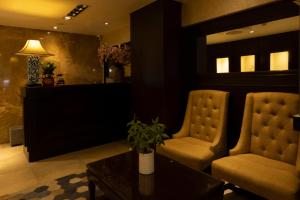 two chairs and a table in a living room at Anpha Boutique Hotel in Ho Chi Minh City