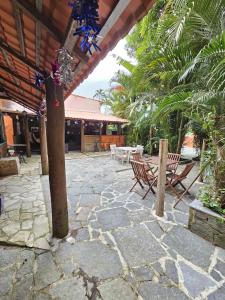 a patio with a table and chairs and a pole at Hospedaria do Engenho in Niterói