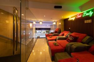 a waiting room with red couches and a neon sign at Anpha Boutique Hotel in Ho Chi Minh City