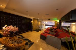 a large room with a bed and chairs in it at Anpha Boutique Hotel in Ho Chi Minh City