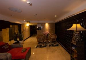 a living room with a couch and a table at Anpha Boutique Hotel in Ho Chi Minh City