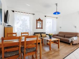 a living room with a couch and a table at Holiday Home Dul by Interhome in Lovas