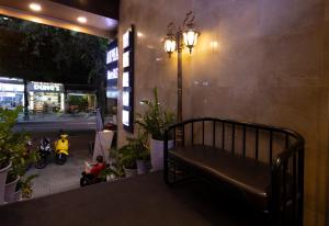 a bench sitting on the side of a building at Anpha Boutique Hotel in Ho Chi Minh City