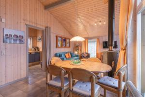 a kitchen and dining room with a table and chairs at Seeschwalbe 54 in Rechlin