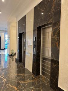 a lobby with a elevator in a building at Luxury apartments Capital City in Shymkent