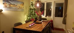 a dining room table with a christmas tree in the background at The Cloudberry Hostel in Näsåker +18 photos