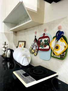 a kitchen counter with a stove top oven in a kitchen at Mochastay in Dehradun +36 photos