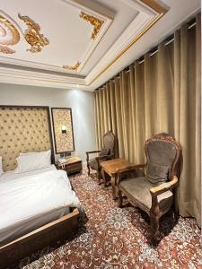 En eller flere senger på et rom på Hotel Delight Skardu