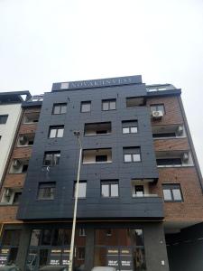 a tall building with a black facade at Apartman "CHARLIZE" with PRIVATЕ PARKING in Novi Sad