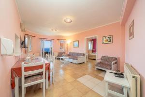 a living room with a table and chairs at Stella Hotel Apartments in Fiskardo