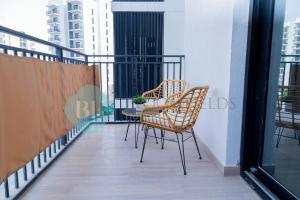 two chairs and a table on a balcony at Bloomfields Elegant 1br In Waters Edge Yas Island in Yas Island