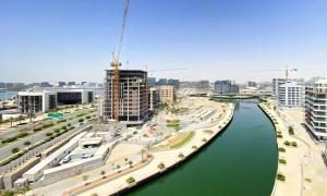 a view of a river in a city with buildings at Bloomfields Cozy Stu In The View Raha Beach in Abu Dhabi