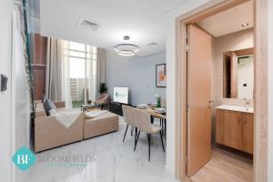 a living room with a couch and a table at Bloomfields Premium 1br Duplex In Rukan in Nadd Shubayḩ