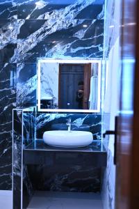a bathroom with a white sink and a mirror at Oslo Rezidor in Islamabad +18 photos