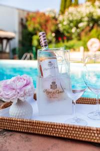 a bottle of wine sitting on a table with glasses at Hotel Pago De Cirsus in Ablitas