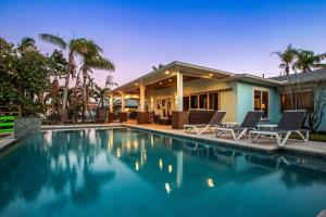 a house with a swimming pool in front of a house at Sunset Splash in Clearwater Beach