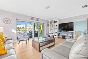 a living room with a couch and a tv at Sunset Splash in Clearwater Beach